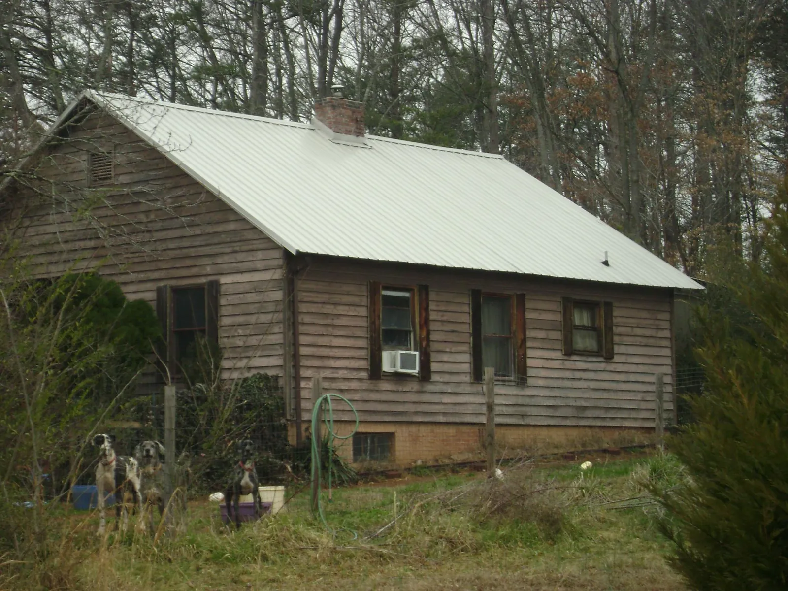 White metal roof on an old wood sided farmhouse, from a Metal Roof Installation job in Montour